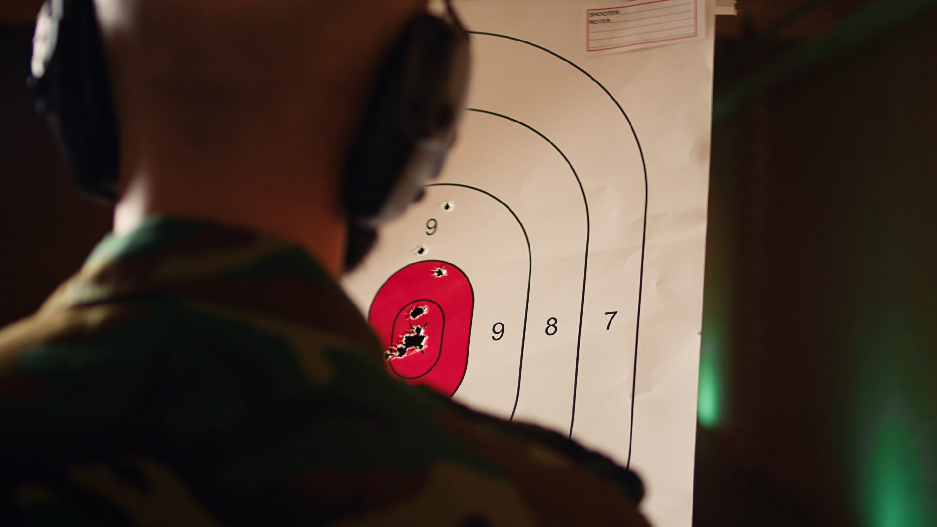 Man holding gun enjoying recreational indoor shooting, close up
